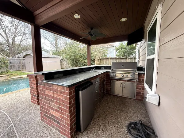 a kitchen with stainless steel appliances granite countertop a sink a stove and a refrigerator