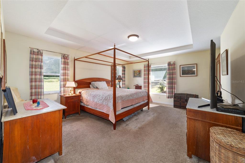 12932 Southwest 41st Place Ocala, FL 34481 - Photo 11 of 29 a bedroom with bed and a flat screen tv