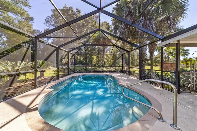 a view of swimming pool with an outdoor space and seating area