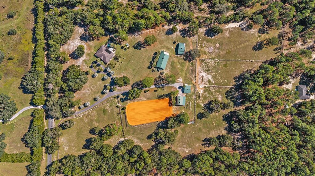 12932 Southwest 41st Place Ocala, FL 34481 - Photo 2 of 29 an aerial view of residential house with swimming pool and lawn chairs