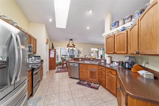 a kitchen with stainless steel appliances a sink a stove and cabinets