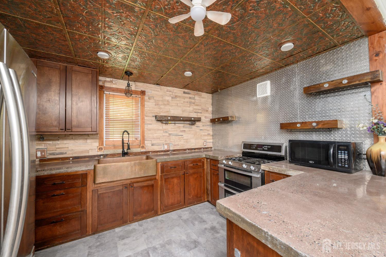 212 Echo Avenue Edison, NJ 08837 - Photo 13 of 42 a kitchen with stainless steel appliances granite countertop a sink a stove and a refrigerator