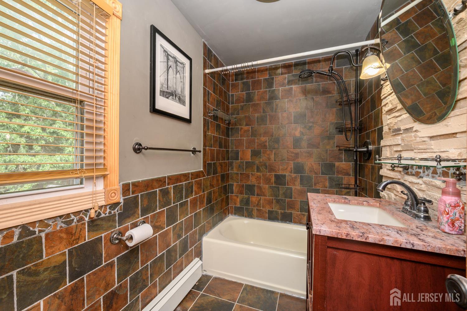 212 Echo Avenue Edison, NJ 08837 - Photo 23 of 42 a bathroom with a granite countertop sink and a bathtub