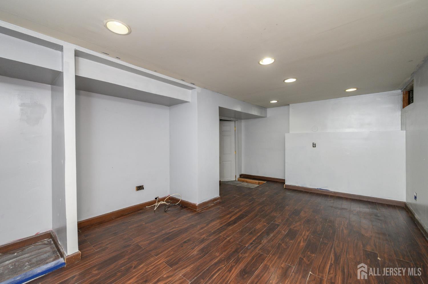 212 Echo Avenue Edison, NJ 08837 - Photo 32 of 42 a view of an empty room with wooden floor