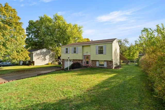 a view of a house with a yard and sitting area
