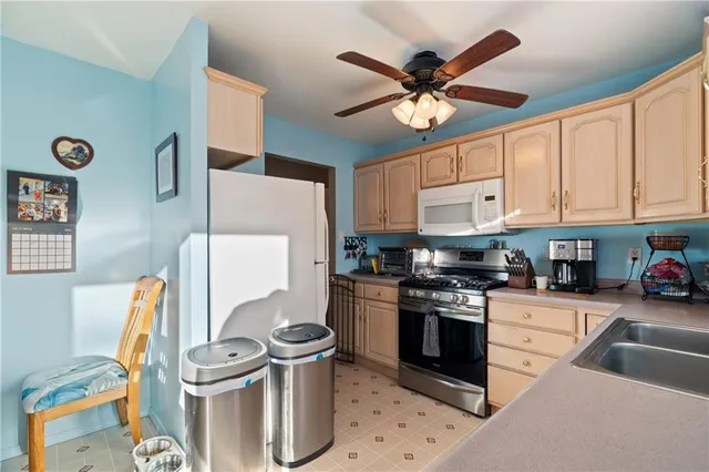 a kitchen with a sink appliances and cabinets