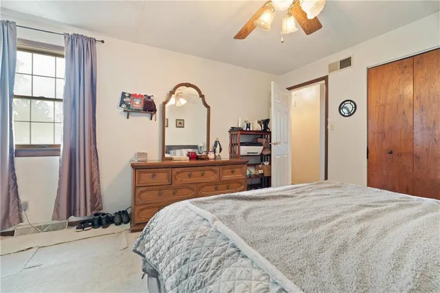 a bedroom with a bed and a dresser