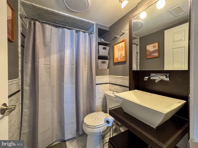 a bathroom with a sink toilet and shower