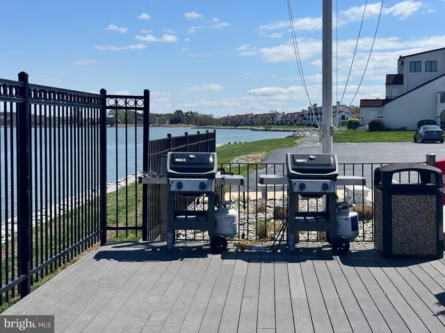 a view of a balcony with wooden floor and outdoor seating