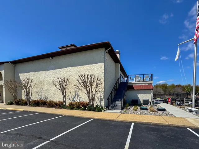 a view of a patio with a table and chairs under an umbrella