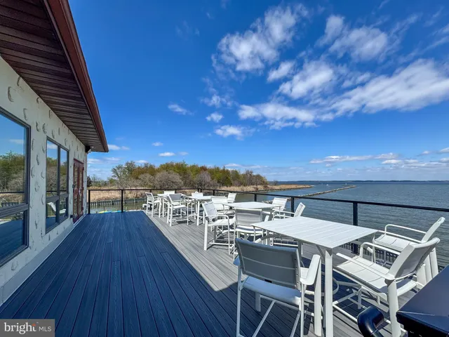a view of a terrace with furniture and wooden floor
