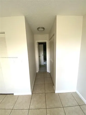 a view of a hallway to rooms