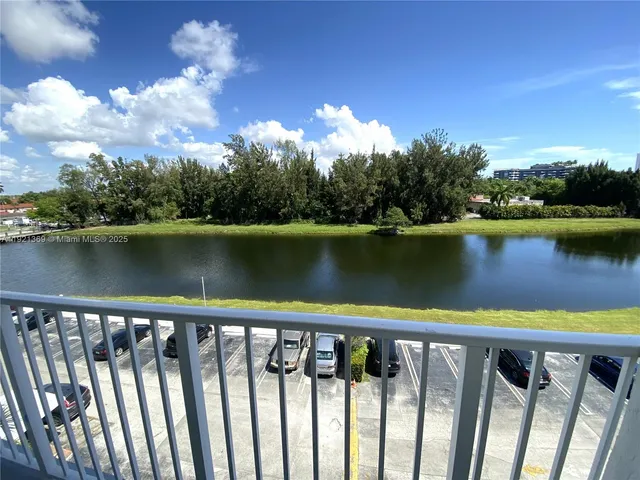 a balcony with wooden floor and lake view