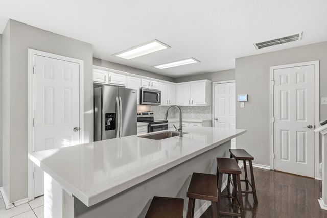 a kitchen with a sink and cabinets