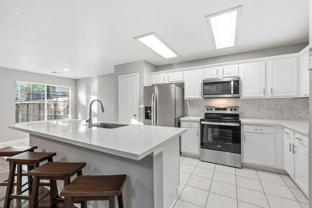 a kitchen with a sink and a stove top oven