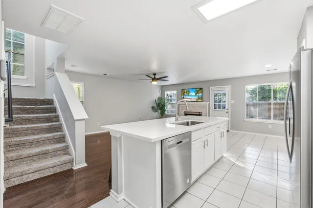 a kitchen with stainless steel appliances a stove microwave and cabinets