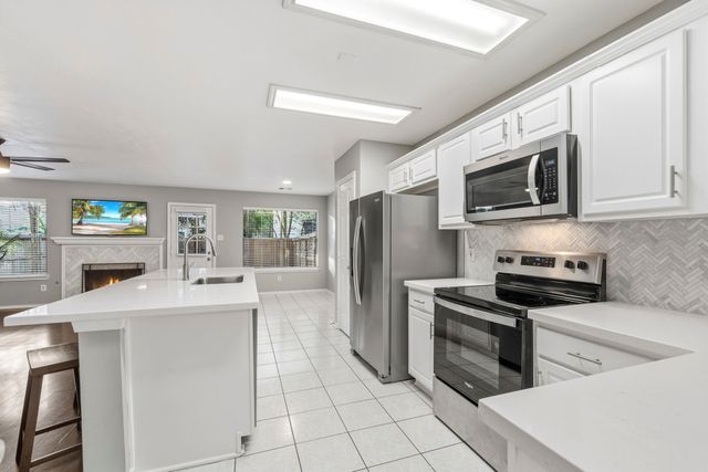 a kitchen with cabinets stainless steel appliances and a counter space