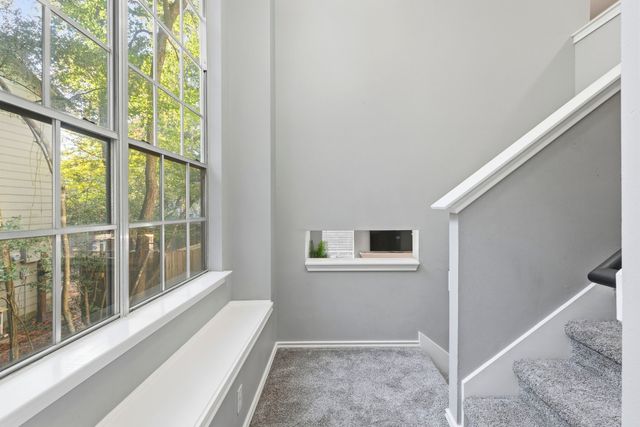 a living room with furniture and a view of kitchen