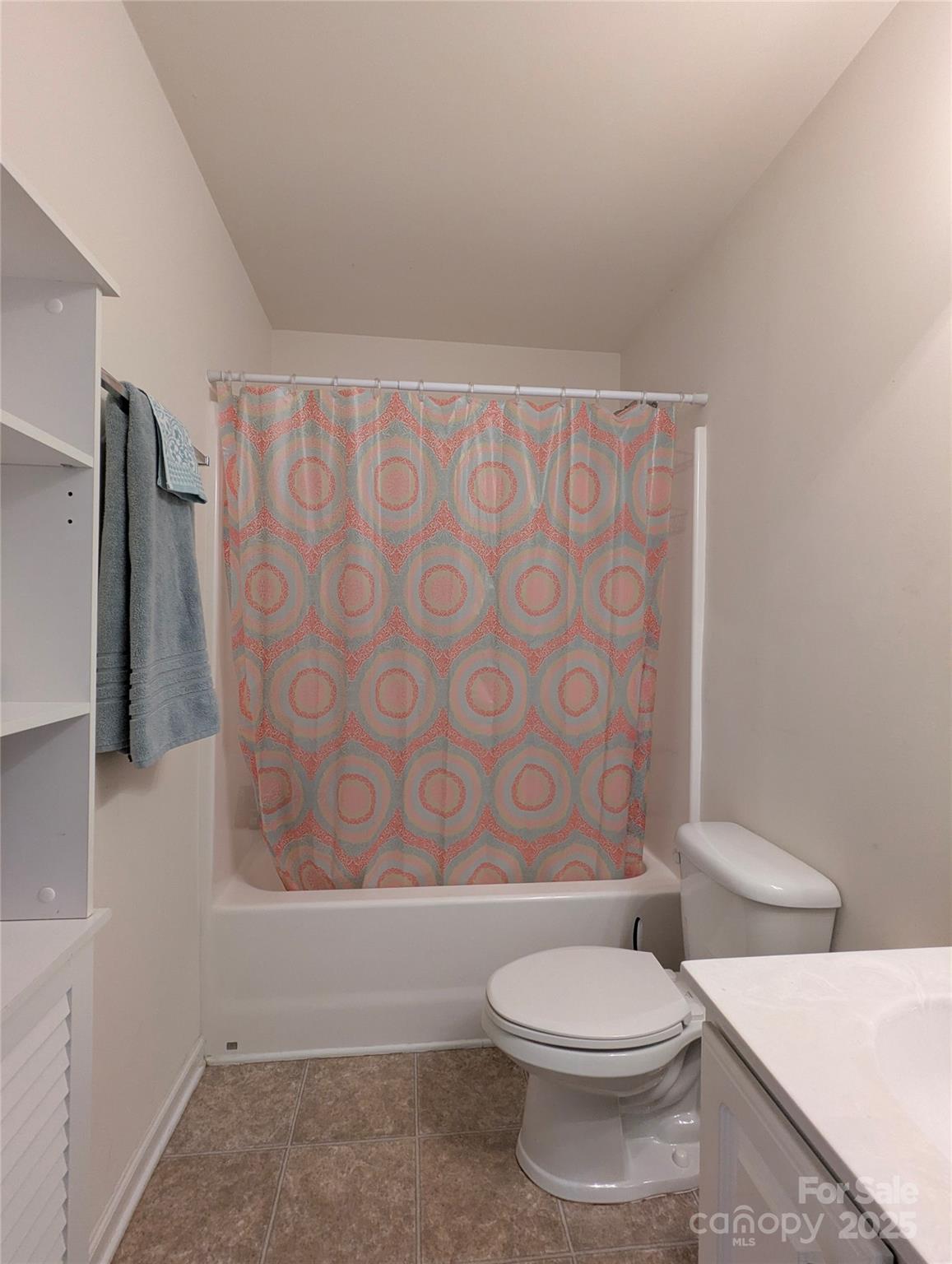 163 West Swift Creek Road Fletcher, NC 28732 - Photo 11 of 26 a white toilet sitting next to a shower curtain