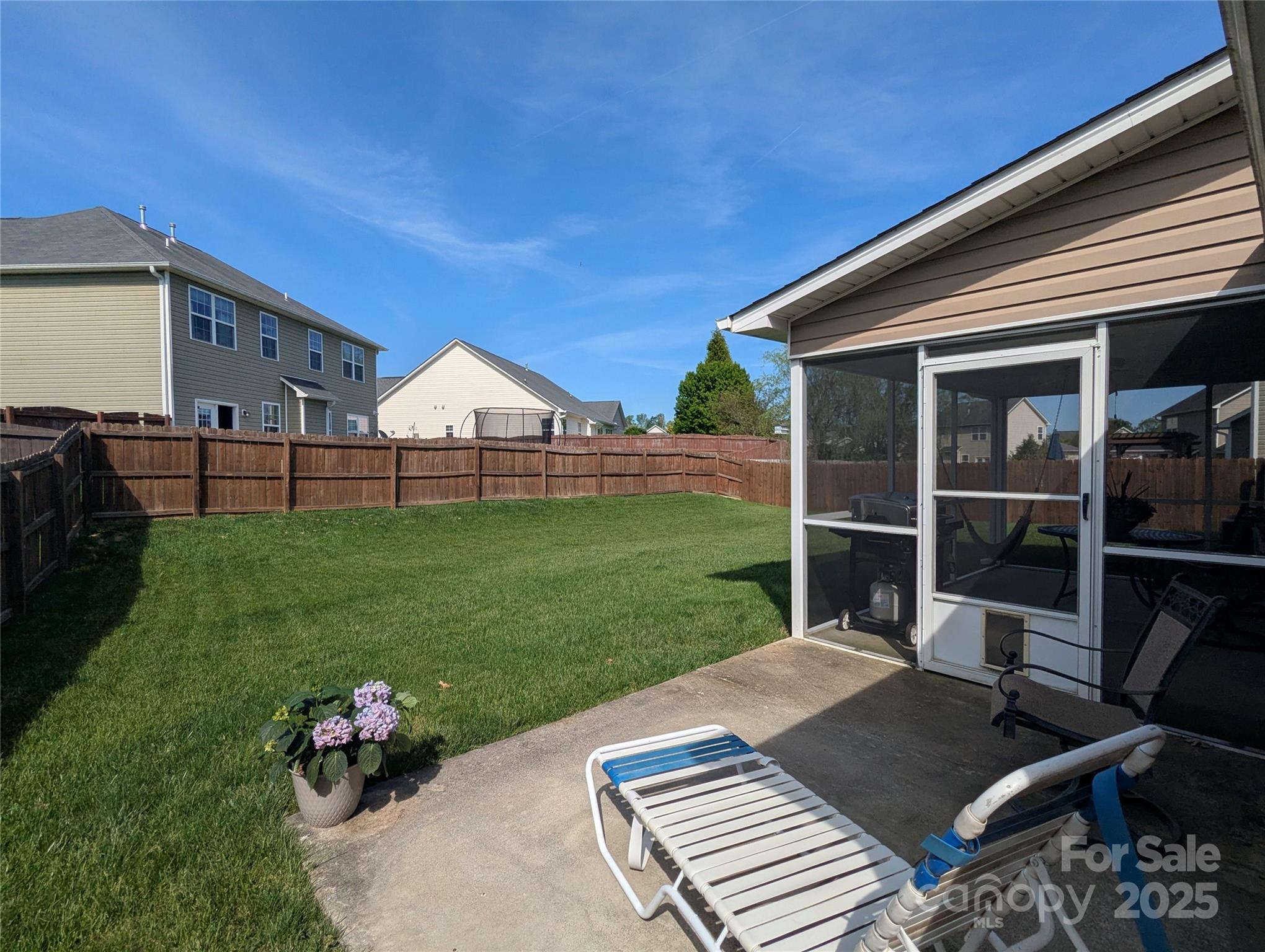 163 West Swift Creek Road Fletcher, NC 28732 - Photo 21 of 26 a view of a backyard with table and chairs and potted plants