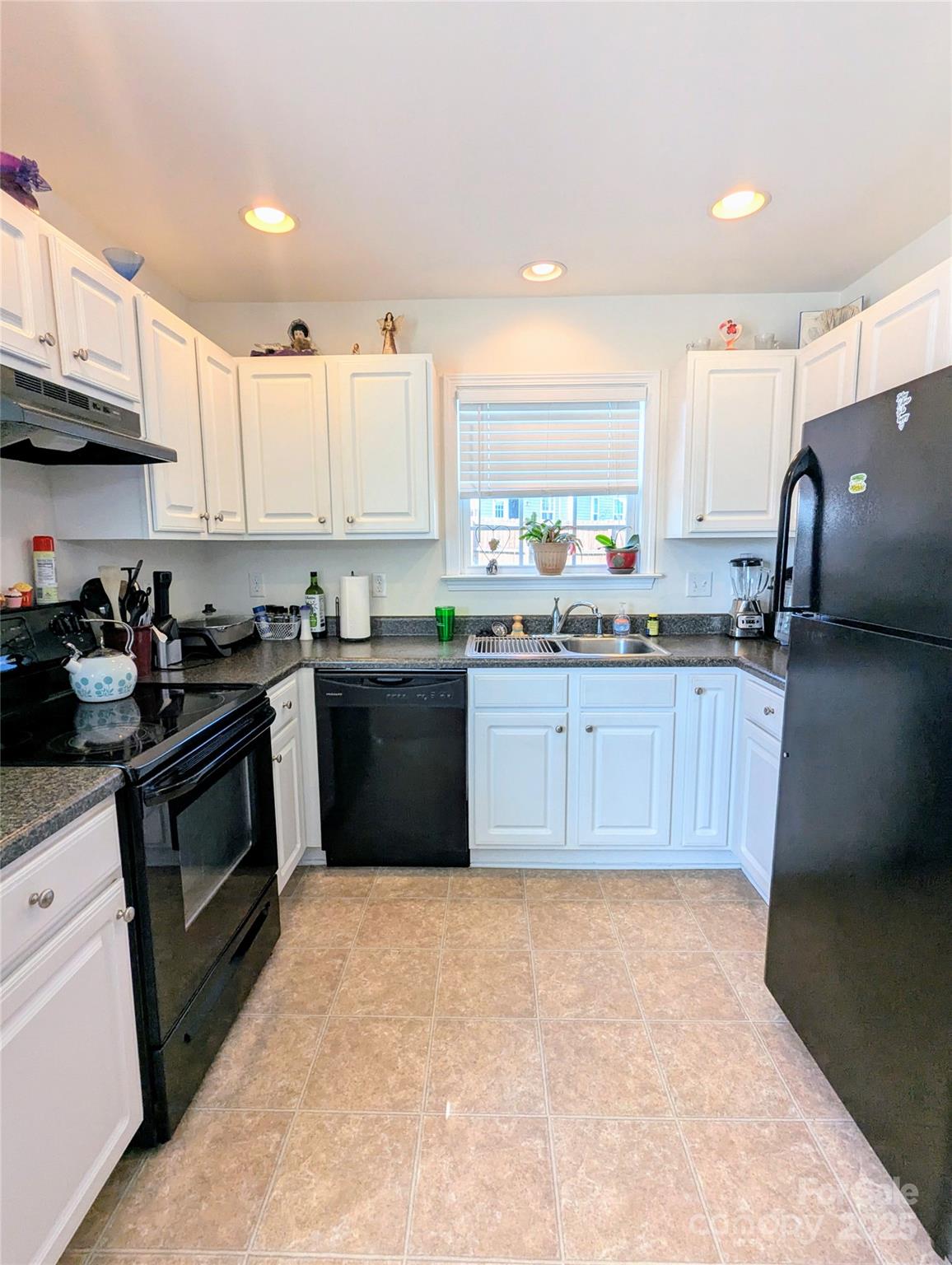 163 West Swift Creek Road Fletcher, NC 28732 - Photo 10 of 26 a kitchen with stainless steel appliances granite countertop a stove top oven a sink dishwasher and a refrigerator with wooden cabinets