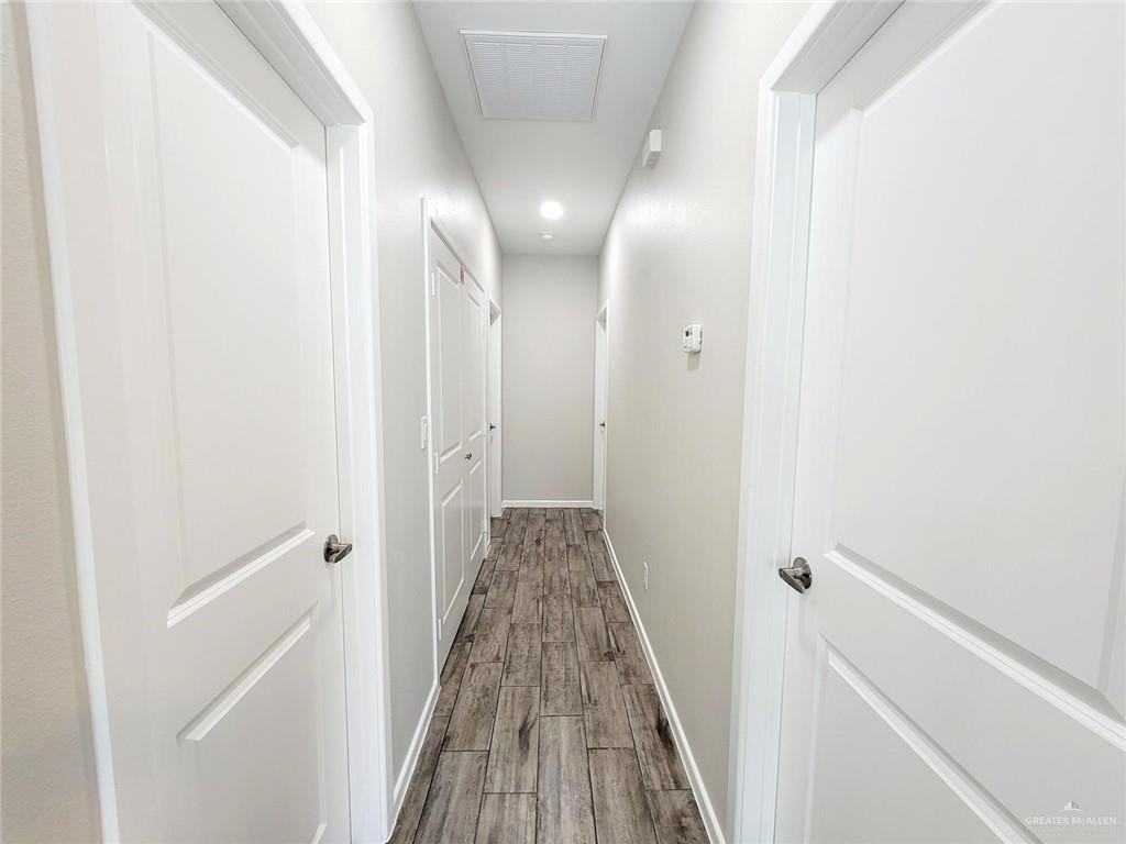 814 East Starr Road, Unit C Mercedes, TX 78570 - Photo 4 of 8 a view of a hallway with wooden floor