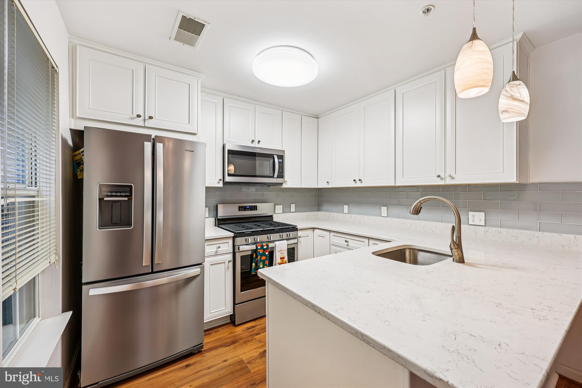 137 Timberbrook Lane, Unit 103 Gaithersburg, MD 20878 - Photo 11 of 51 a kitchen with granite countertop a refrigerator stove and sink