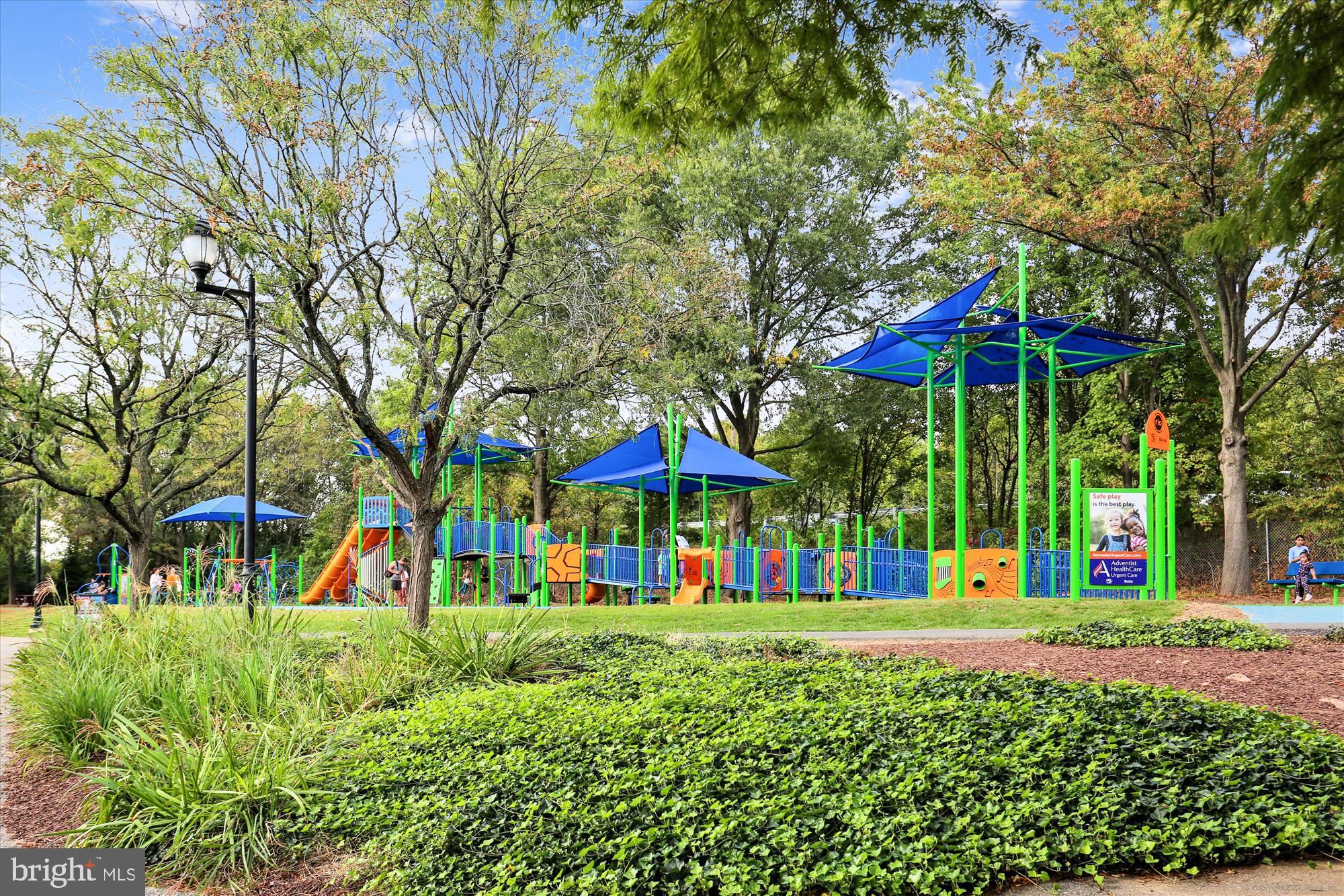 137 Timberbrook Lane, Unit 103 Gaithersburg, MD 20878 - Photo 47 of 51 a view of a park with large trees and plants