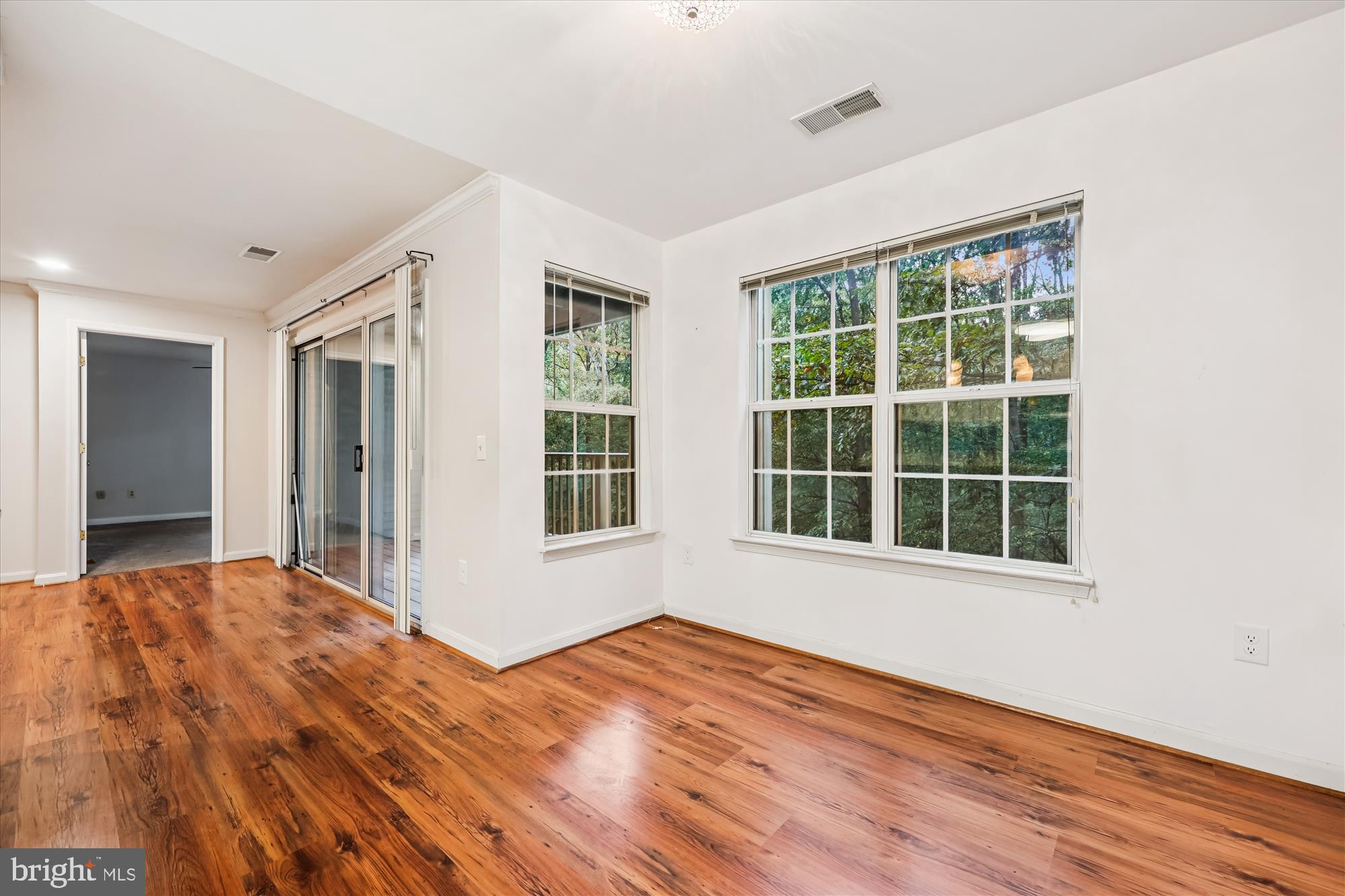137 Timberbrook Lane, Unit 103 Gaithersburg, MD 20878 - Photo 8 of 51 a view of an empty room with wooden floor and a window