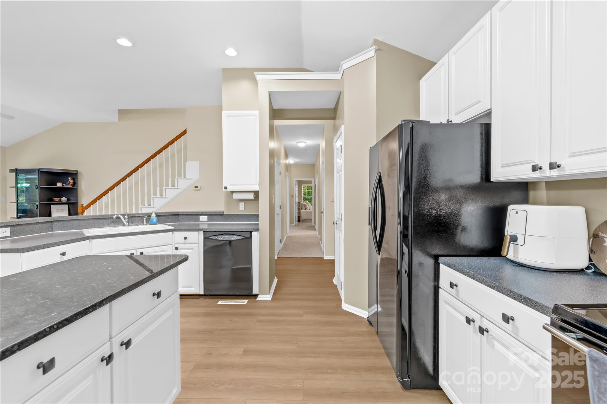 11113 Asbury Chapel Road Huntersville, NC 28078 - Photo 14 of 40 a kitchen with a refrigerator and a sink