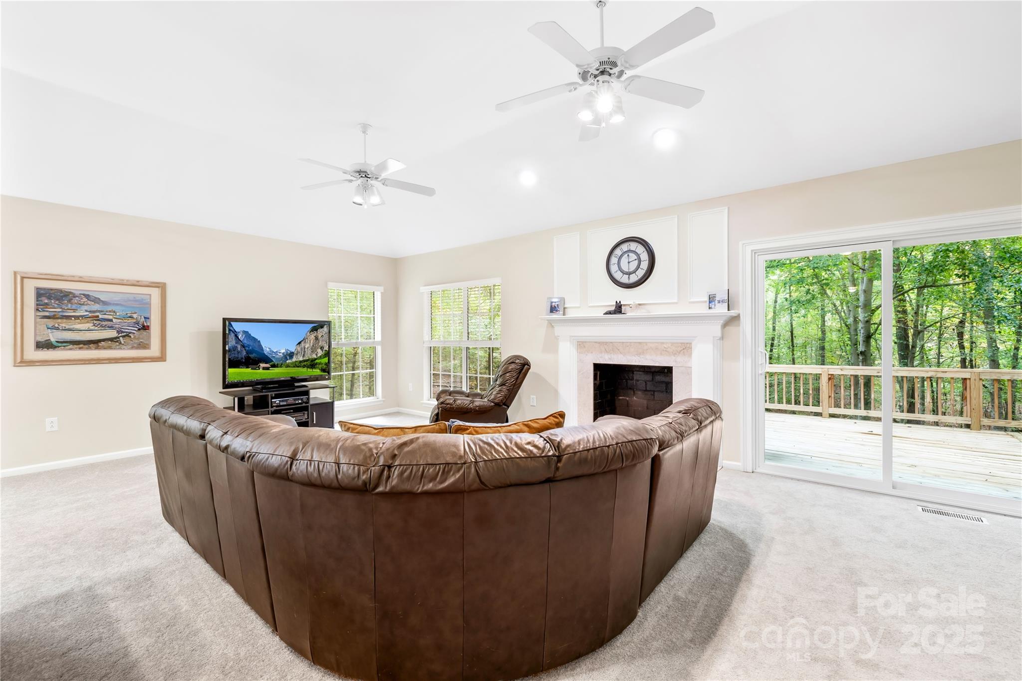 11113 Asbury Chapel Road Huntersville, NC 28078 - Photo 19 of 40 a living room with fireplace furniture a flat screen tv and a large window