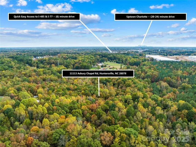 a view of a house with a yard and large tree