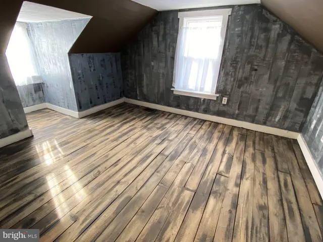a view of wooden floor and windows in a room