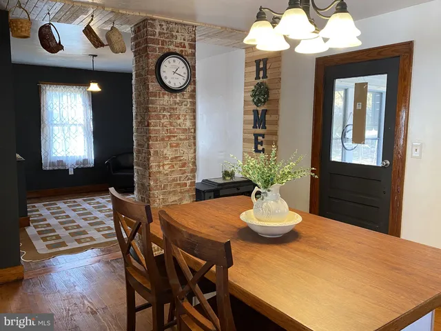 a view of a dining room with furniture and a chandelier