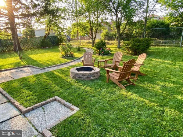 a view of a backyard with table and chairs and garden