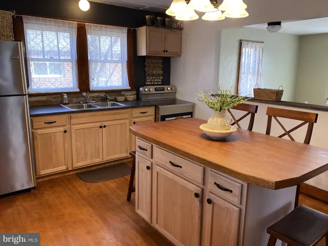 a kitchen with cabinets a sink and appliances