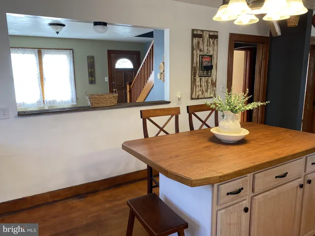 a view of kitchen island with furniture and wooden floor