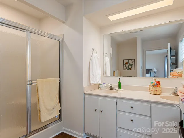 a bathroom with a shower sink and mirror