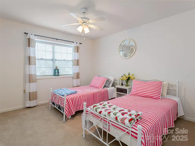 a bedroom with two beds and a window