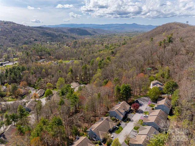 an aerial view of a houses with a street