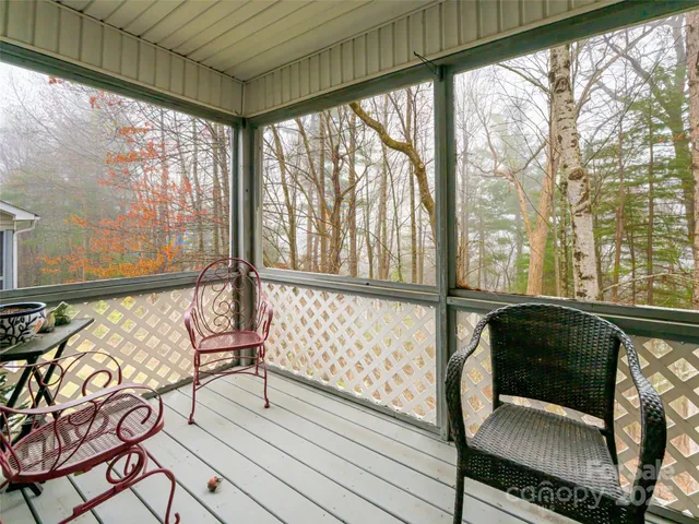 a view of a room with wooden floor and furniture