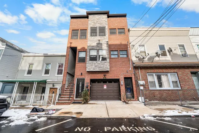 a kitchen with granite countertop a refrigerator stove and sink