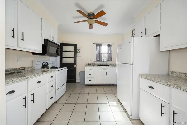 a kitchen with appliances cabinets and a sink