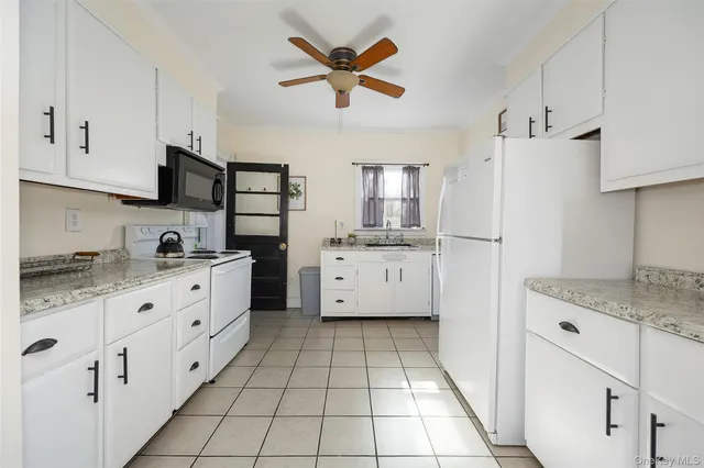 a kitchen with appliances cabinets and a sink