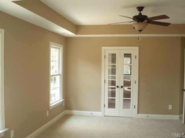 661 Shelley Road Raleigh, NC 27609 - Photo 3 of 8 an empty room with windows and fan