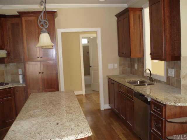661 Shelley Road Raleigh, NC 27609 - Photo 6 of 8 a bathroom with a granite countertop sink a toilet and shower