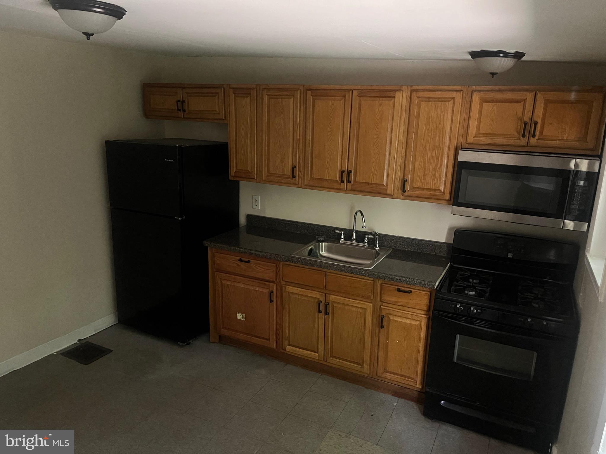 405 East Rittenhouse Street Philadelphia, PA 19144 - Photo 6 of 12 a kitchen with stainless steel appliances granite countertop a stove and a microwave oven