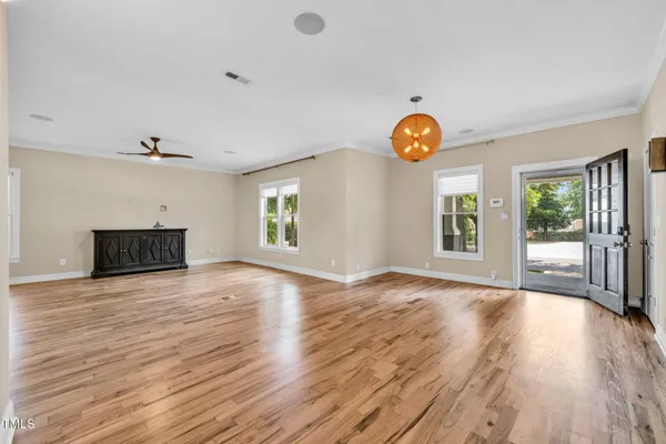 wooden floor in an empty room with a window