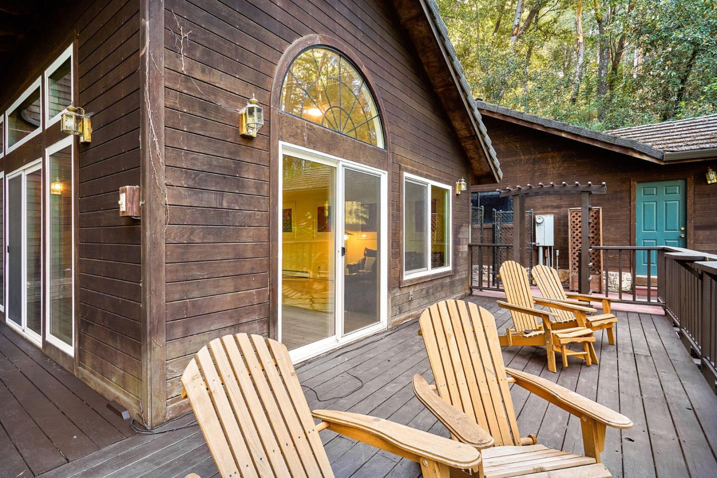170 Swett Road Woodside, CA 94062 - Photo 31 of 36 a view of a patio with table and chairs next to a yard