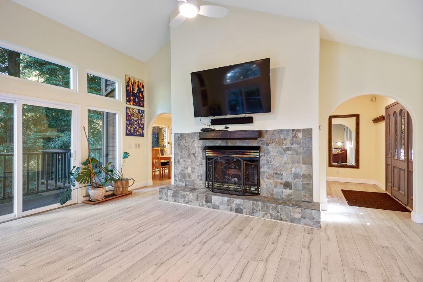 170 Swett Road Woodside, CA 94062 - Photo 6 of 36 a living room with fireplace furniture and a flat screen tv